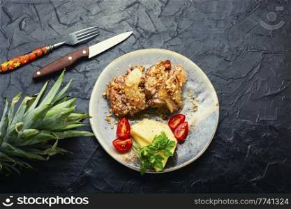 Tasty piece of pork roasted with cheese and pineapple. Copy space. Piece pork baked with pineapple