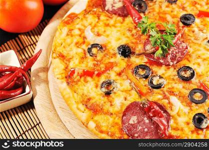 Tasty pizza on wooden plate close up
