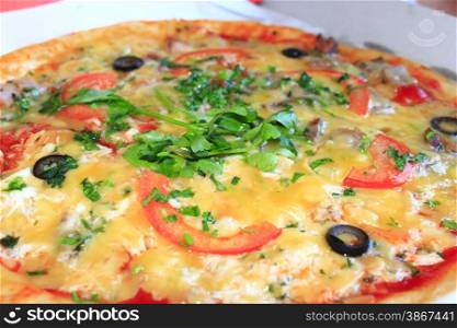 tasty pizza with an appetizing stuffing and verdure. pizza with an appetizing stuffing