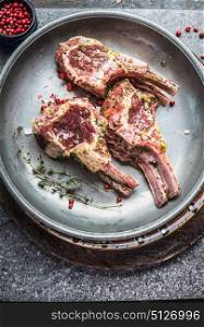 Tasty raw fresh Lamb Meat ribs and seasonings in dish , top view, close up