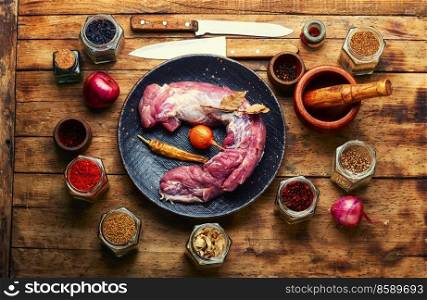 Tasty raw pork meat for cooking. Raw meat tenderloin and spices.Top view. Uncooked pork meat, fresh meat