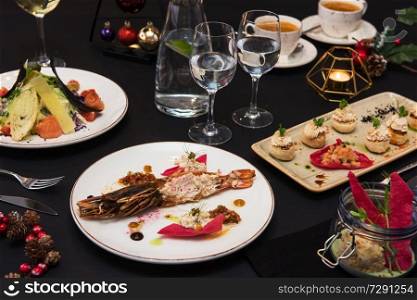 Tasty restaurant dishes: Cooked and stuffed crayfish, salad, appetizers, and crayfish ice-cream. Tasty restaurant dishes