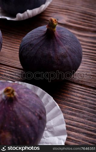 tasty ripe figs fruit on wooden table. close up
