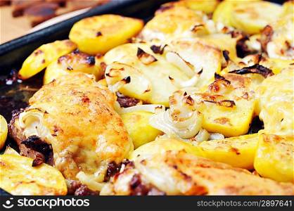 Tasty roast chicken with potato and cheese. close up