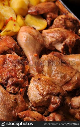 Tasty roast chicken with potato close up