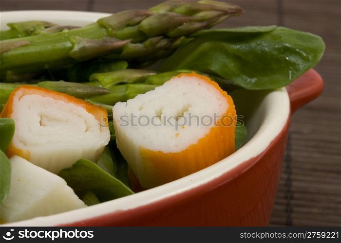 tasty salad. a close up photo of a salad with asparagus and surimi