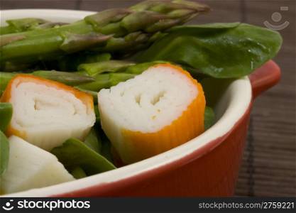 tasty salad. a close up photo of a salad with asparagus and surimi