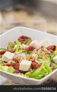 tasty salad closeup. Salad feta cheese lettuce sausage cucumbers and pine nuts