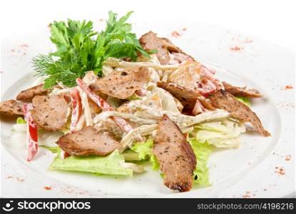 Tasty salad of meat and vegetable dish close up on a white background