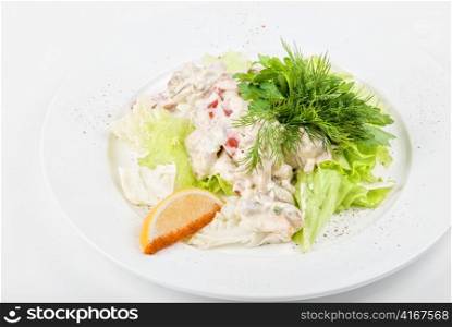 Tasty salad of seafood and vegetable dish close up on a white background