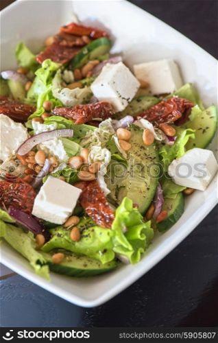 tasty salad. Salad feta cheese lettuce sausage cucumbers and pine nuts