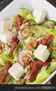 tasty salad. Salad feta cheese lettuce sausage cucumbers and pine nuts