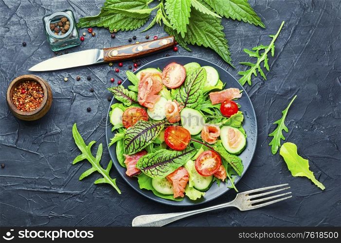 Tasty salad with trout,cherry tomato,cucumber and herbs. Mixed green salad with salted salmon