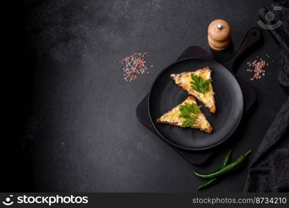 Tasty sandwich with crunchy toast with egg and cheese. Drinking breakfast on a dark concrete background. Tasty sandwich with crunchy toast with egg and cheese