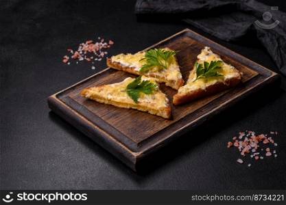 Tasty sandwich with crunchy toast with egg and cheese. Drinking breakfast on a dark concrete background. Tasty sandwich with crunchy toast with egg and cheese