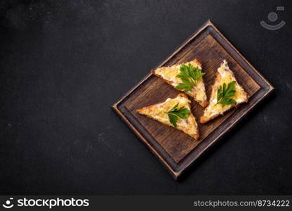 Tasty sandwich with crunchy toast with egg and cheese. Drinking breakfast on a dark concrete background. Tasty sandwich with crunchy toast with egg and cheese