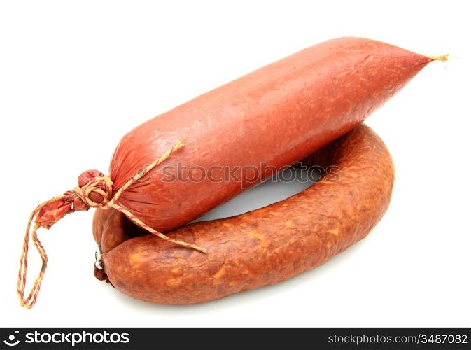 Tasty sausage is curtailed by a ring lies on a white background