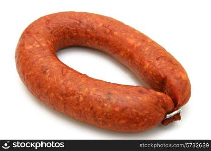 Tasty sausage is curtailed by a ring lies on a white background&#xA;