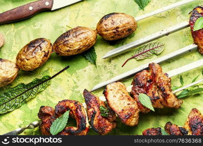 Tasty shashlik on skewers with nettle marinade.Grilled meat skewers. Kebabs or grilled meat