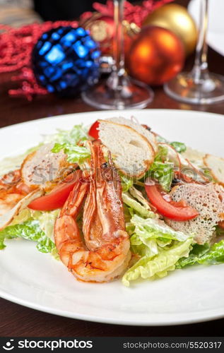 Tasty shrimp salad with vegetables on christmas table