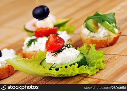 Tasty small sandwich from vegetables and cheese on bamboo napkin