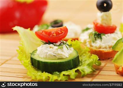 Tasty small sandwich from vegetables and cheese on bamboo napkin
