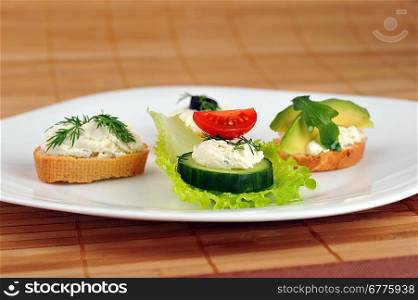 Tasty small sandwich from vegetables and cheese on dish