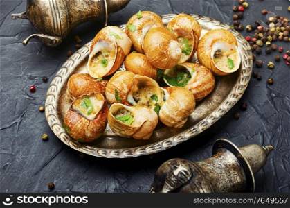Tasty snails in vintage tray.Stuffed escargots.France food. Delicacy stuffed snails