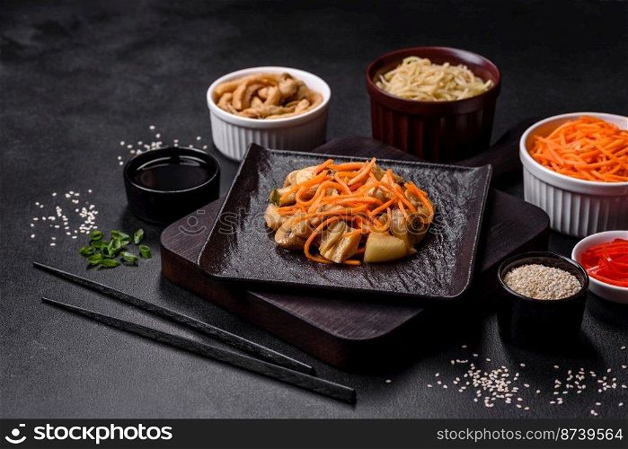 Tasty spicy Korean mushroom with spices and herbs on a dark concrete background. Asian food. Tasty spicy Korean mushroom with spices and herbs on a dark concrete background