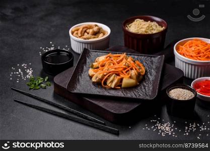 Tasty spicy Korean mushroom with spices and herbs on a dark concrete background. Asian food. Tasty spicy Korean mushroom with spices and herbs on a dark concrete background