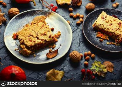 Tasty traditional autumn pie. Sweet pumpkin cake on a plate. Delicious pumpkin pie