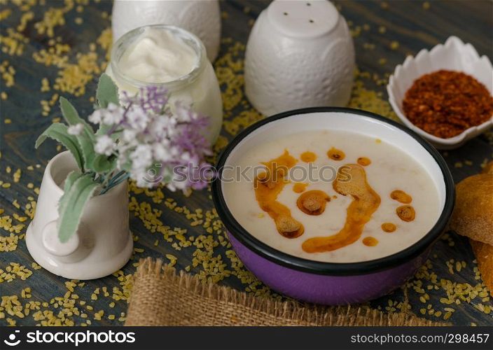Tasty traditional soup and flower on wooden table.Top view.