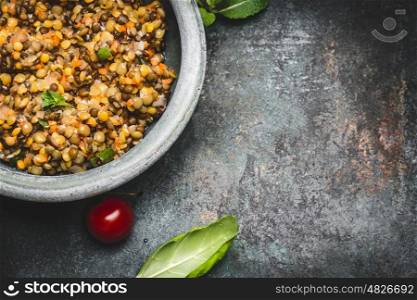 Tasty vegetarian red lentil salad in bowl on rustic background, top view, close up, border. Healthy eating, Vegetarian or vegan food concept