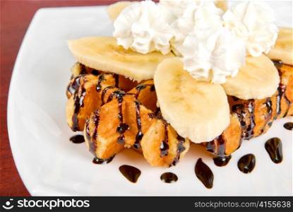 Tasty waffle with banana slices and ice cream
