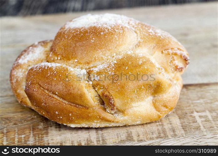 Tasty wheat bun lying on a wooden board on the chopping board, Simple kitchen. Tasty wheat bun