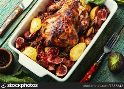 Tasty whole partridge in a baking dish. Baked chicken .. Roasted chicken with figs