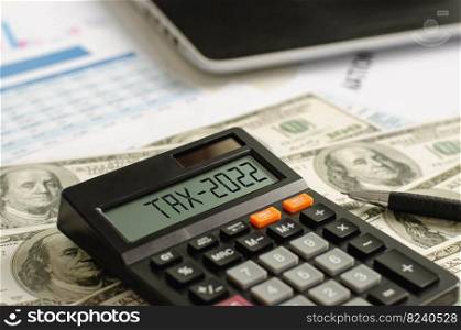tax assistance with dollar-denominated banknotes On the display of the 2022 calculator, tax assistance, tax deductions are written.