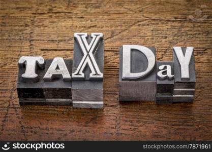 tax day - financial concept - words in mixed vintage metal type printing blocks over grunge wood