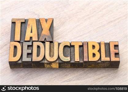 tax deductible word abstract in vintage lettepress wood type, finance concept