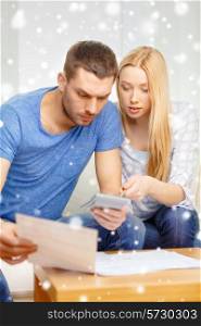 tax, finances, family, home and people concept - busy couple with papers and calculator at home
