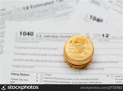 Tax form 1040 for tax year 2012 for US individual tax return with gold coins
