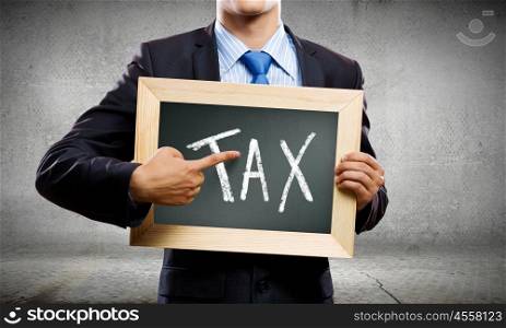 Tax pay. Close up of businessman holding frame with drawn text