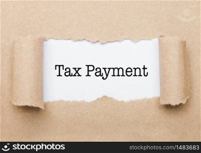 Tax Payment concept text appearing behind torn brown paper envelope