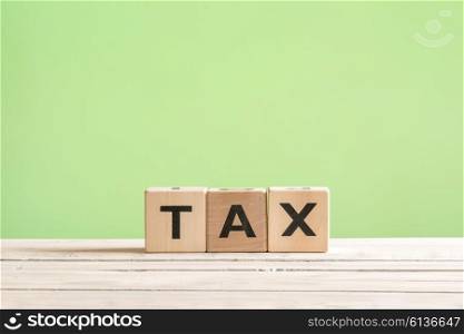 Tax sign made of wood on a green background