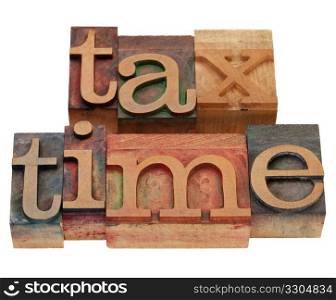 tax time words in vintage wooden letterpress printing blocks, stained by color inks, isolated on white
