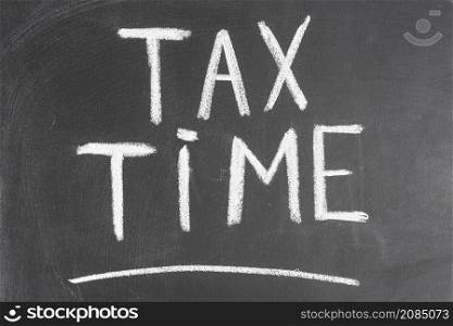 tax time written black backboard with chalk