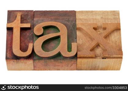 tax word in vintage wooden letterpress printing blocks, stained by color inks, isolated on white