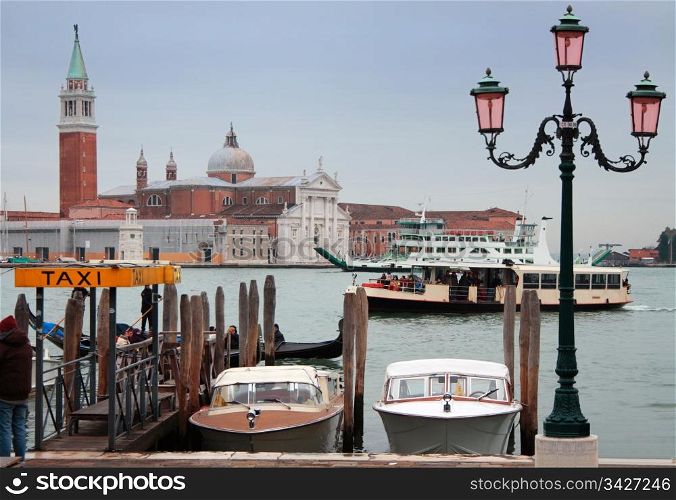 Taxi boats, gondola, vaporetto and ferry boat in front of San Giogio Maggiore Island, Venice, Italy