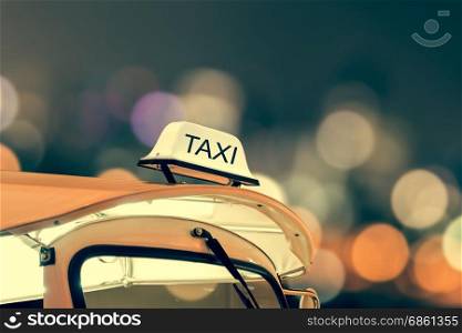 Taxi car on street and bokeh at night life, vintage theme