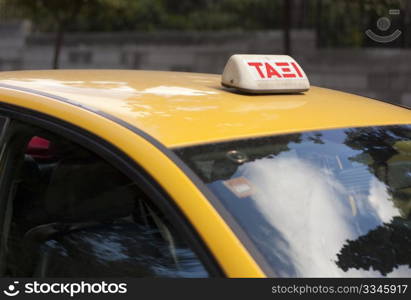 Taxi sign on yellow taxi in Athens, Greece.